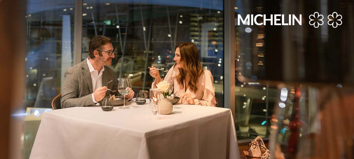 happy couple enjoys fine dining in the bmw welt dining room