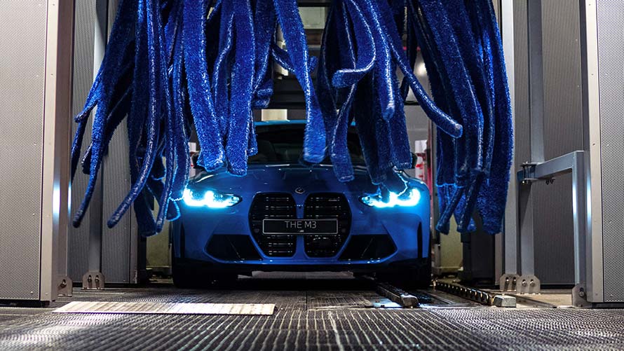 Blue BMW gets a cleaning in the car wash