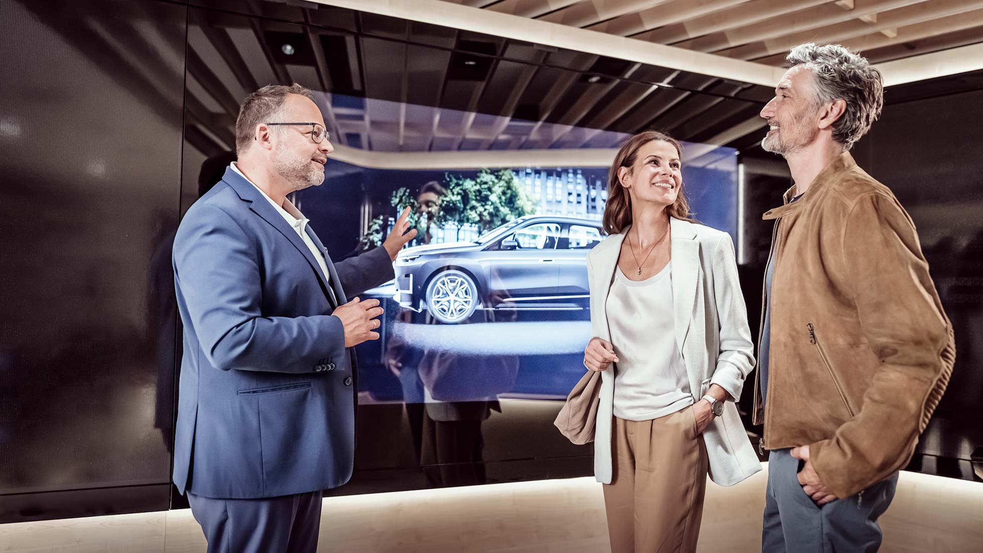 Smiling couple at the Product Info Center of BMW Welt presenting their BMW model