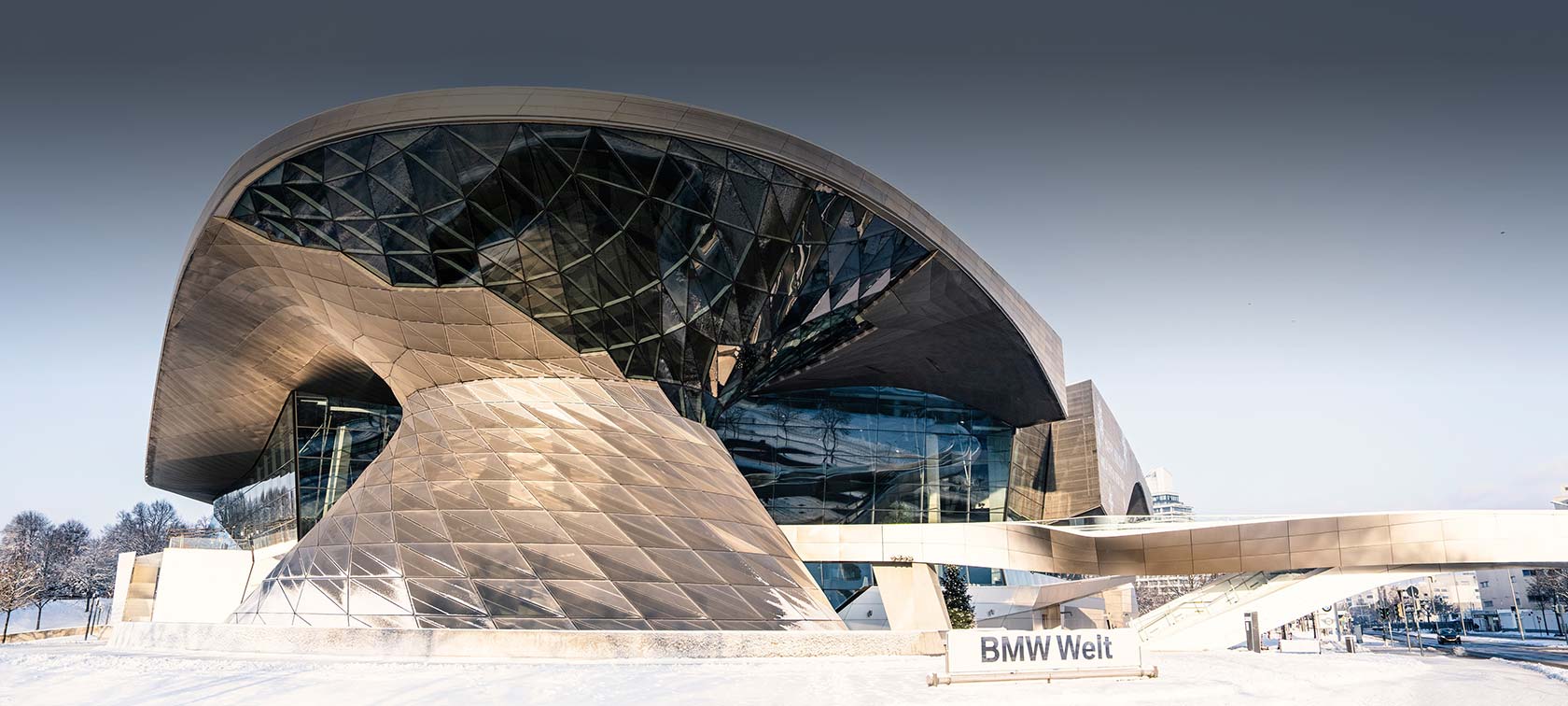 Exterior view of the Double Cone of BMW Welt illuminated in red