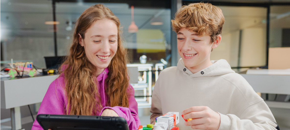 BMW Tinkerbot Workshop Two children build a Lego model in a BMW Welt workshop