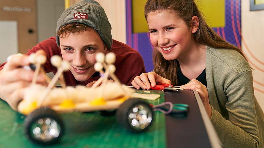 BMW Creative for 14 year olds Teenage boy and girl tinker together on wooden car model